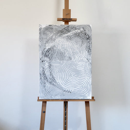 Abstract black and white acrylic landscape painting displayed on a wooden easel.
