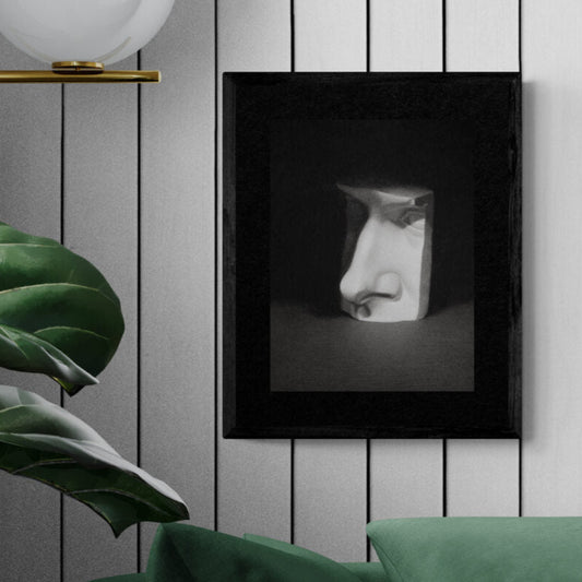 Framed artwork of a stylized face on a wall with decorative elements.