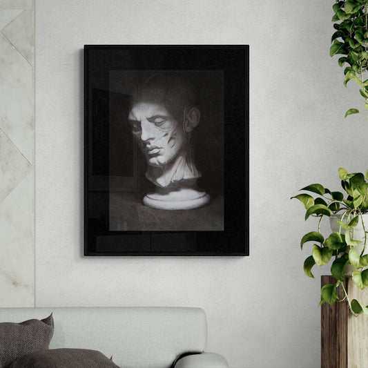 Framed black and white portrait on a wall above a sofa with plants in the background